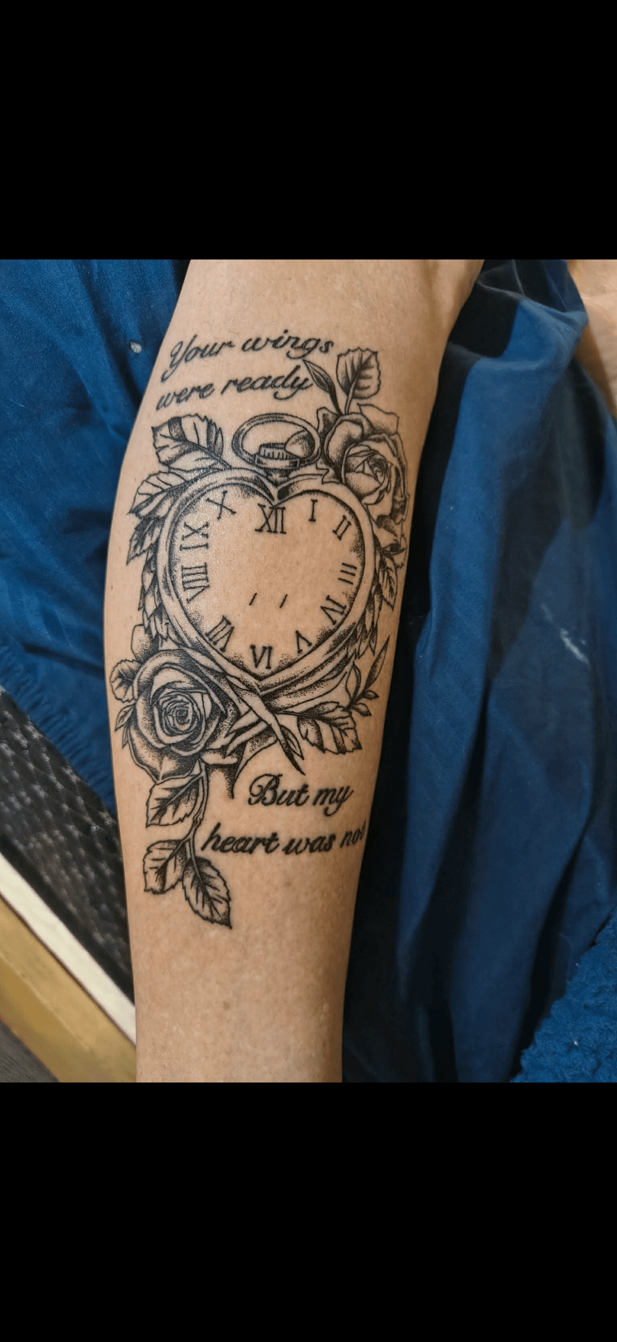 Heart-shaped clock tattoo with roses and text: Your wings were ready but my heart was not.